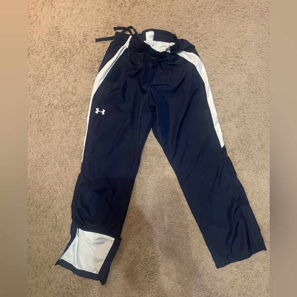 Women’s Under Armour Dark Blue Athletic Pants with White Stripes.